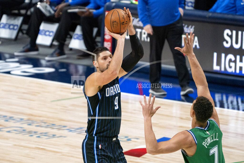 Jeffrey Mcwhorter Orlando Magic center Nikola Vucevic (9) shoots a three-point basket over Dallas Mavericks center Dwight Powell (7) during the first half of an NBA basketball game, Saturday, Jan. 9, 2021, in Dallas. (AP Photo/Jeffrey McWhorter)