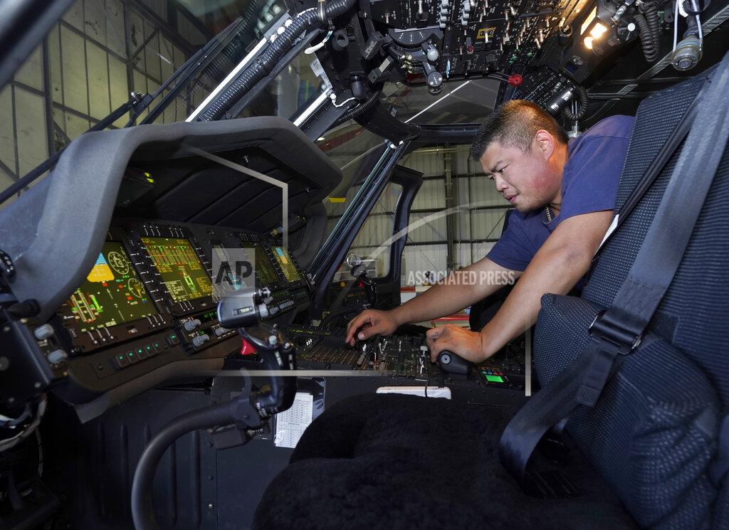 Rich Pedroncelli Avionics mechanic Mike Luong inspects the control panel of Sikorsky Firehawk helicopter at the California Department of Forestry and Fire Protection's Sacramento Aviation Management Unit based at McClellan Airpark in Sacramento, Calif., Friday, July 23, 2021. Firefighters are trying to become smarter in how they prepare for the drought- and wind-driven wildfires that have become more dangerous across the American West in recent years, including by adding aircraft like the Sikorsky Firehawk helicopters or military surplus C-130 transport aircraft retrofitted to drop fire retardant. (AP Photo/Rich Pedroncelli)