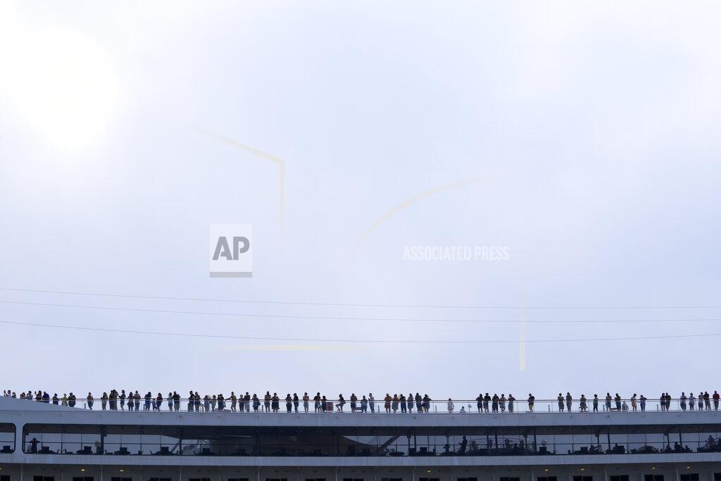 Antonio Calanni Passengers stand on the deck of the 92,409-ton,16-deck MSC Orchestra cruise ship as it departs from Venice, Italy, Saturday, June 5, 2021. The first cruise ship leaving Venice since the pandemic is set to depart Saturday amid protests by activists demanding that the enormous ships be permanently rerouted out the fragile lagoon, especially Giudecca Canal through the city's historic center, due to environmental and safety risks. (AP Photo/Antonio Calanni)