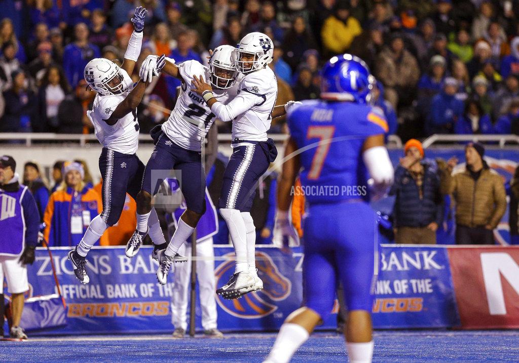 Steve Conner Utah State wide receiver Jalen Greene (21) celebrates with running back Darwin Thompson, left, and quarterback Jordan Love after a touchdown reception during the first half of an NCAA college football game against Boise State on Saturday, Nov. 24, 2018, in Boise, Idaho. (AP Photo/Steve Conner)