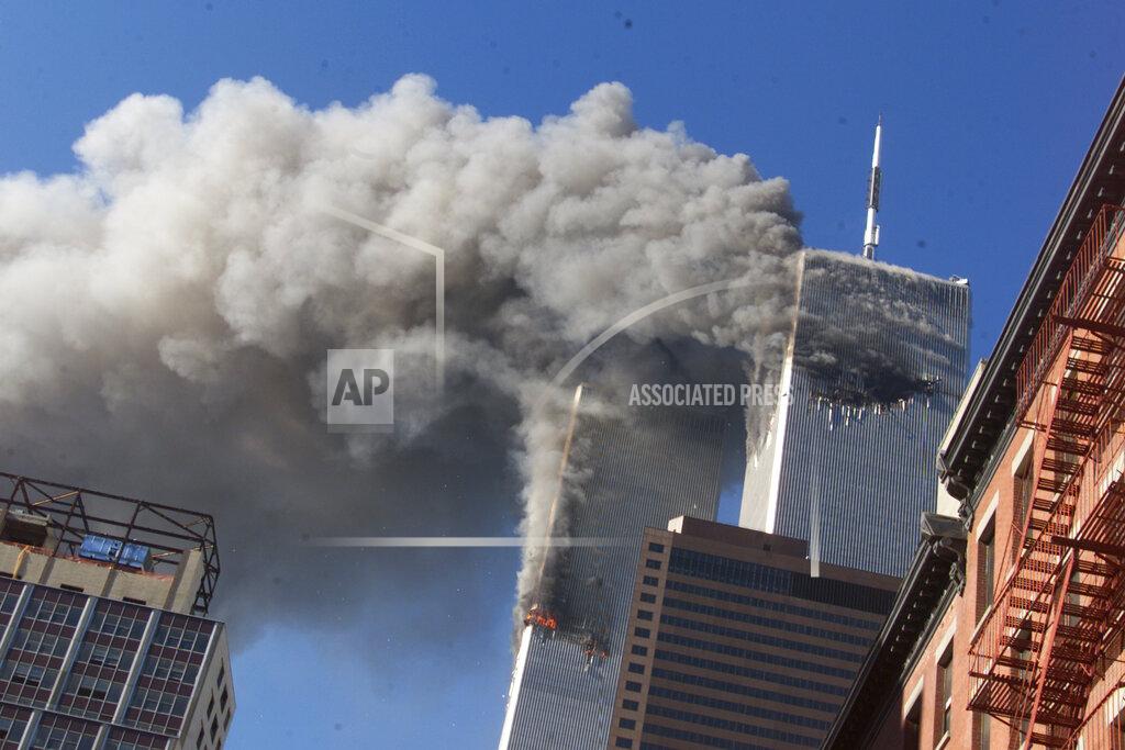 Richard Drew FILE - Smoke rises from the burning twin towers of the World Trade Center after hijacked planes crashed into the towers on September 11, 2001 in New York City. Associated Press photographer Richard Drew talks about AP’s coverage of 9/11 and the events that followed. (AP Photo/Richard Drew)