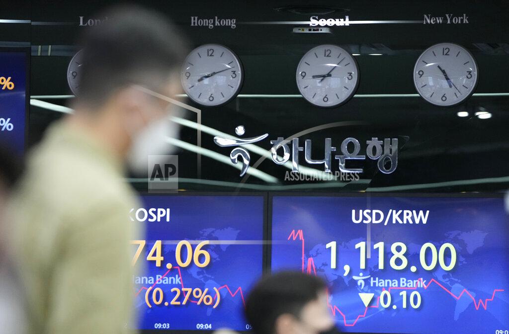 Lee Jin-Man Currency traders watch computer monitors near the screens showing the Korea Composite Stock Price Index (KOSPI), left, and the foreign exchange rate between U.S. dollar and South Korean won at the foreign exchange dealing room in Seoul, South Korea, Friday, May 28, 2021. Asian shares rose Friday, powered by encouraging signs that the U.S. economic recovery from the pandemic is gaining momentum. (AP Photo/Lee Jin-man)