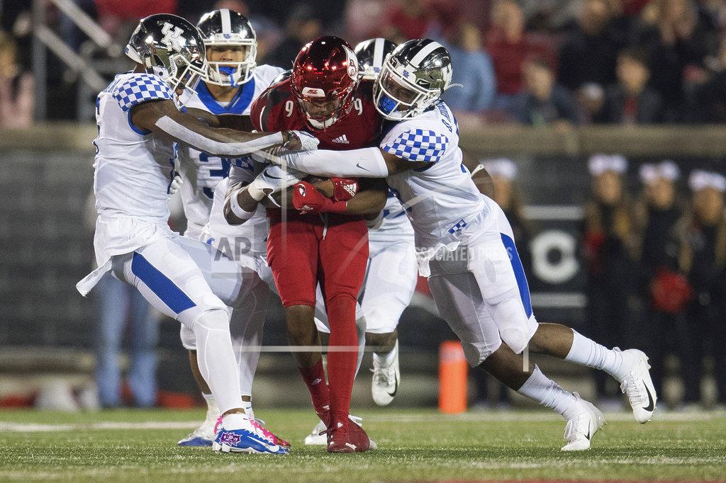 Bryan Woolston Louisville wide receiver Jaylen Smith (9) is tackled by several Kentucky defenders during the second half of an NCAA college football game in Louisville, Ky., Saturday, Nov. 24, 2018. (AP Photo/Bryan Woolston)