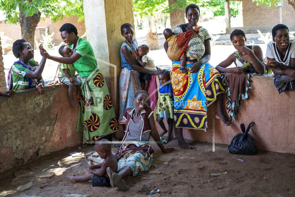 Jerome Delay FILE - In this Wednesday, Dec. 11, 2019 file photo, residents of the Malawi village of Tomali wait to have their young children become test subjects for the world's first vaccine against malaria in a pilot program. The World Health Organization is now warning that the battle against malaria in sub-Saharan Africa, where it routinely kills hundreds of thousands a year, could be set back 20 years as countries focus almost all their energy and resources on containing the coronavirus outbreak. "We must not turn back the clock,” Matshidiso Moeti, WHO regional director for Africa, said Thursday, April 23, 2020. (AP Photo/Jerome Delay, file)