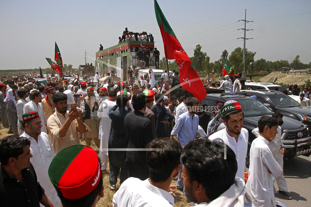 Mohammad Zubair A convey of supporters led by ousted Pakistani Prime Minister Imran Khan, on truck, move towards Islamabad, in Swabi, Pakistan, Wednesday, May 25, 2022. Pakistani police have fired tear gas and scuffled with stone-throwing supporters of Khan as they gathered for planned marches Wednesday toward central Islamabad. The defiant former premier had called followers to a rally outside Parliament to bring down the government and force early elections. (AP Photo/Mohammad Zubair)