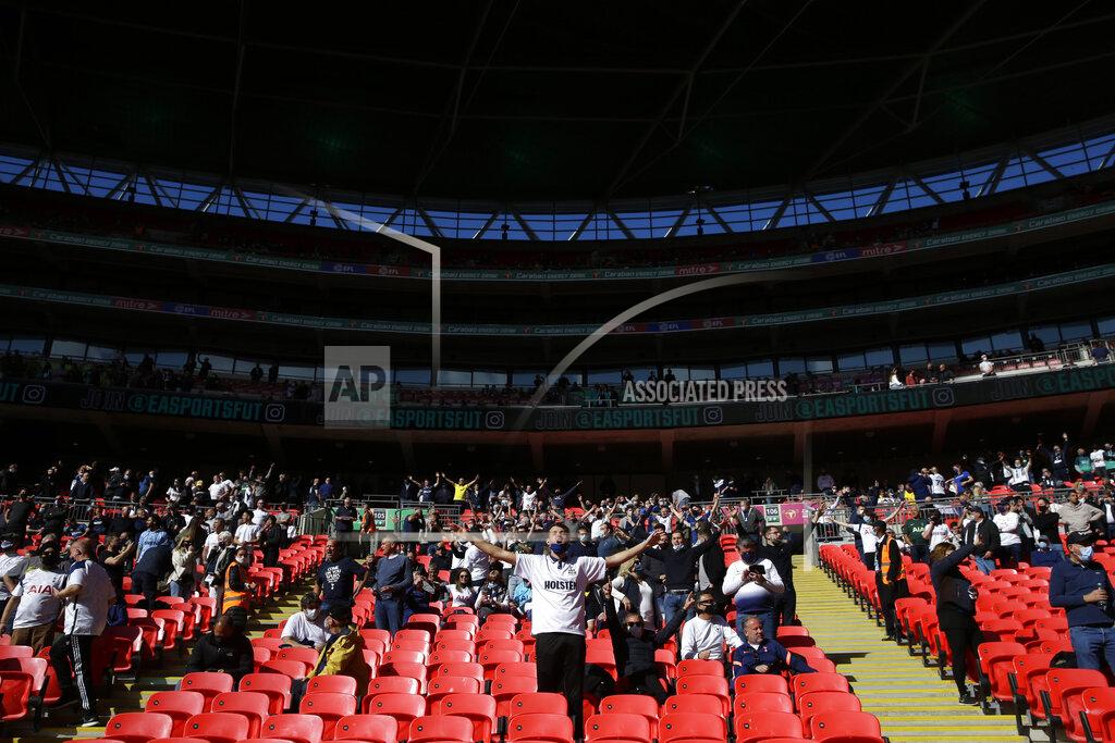 Alastair Grant Tottenham supporters take their socially distanced seats for the English League Cup final soccer match between Manchester City and Tottenham Hotspur at Wembley stadium in London, Sunday, April 25, 2021. Some eight thousand spectators were allowed to attend the match. (AP Photo/Alastair Grant)