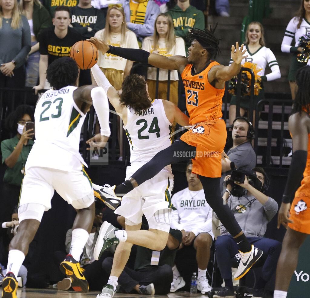 Rod Aydelotte Oklahoma State forward Tyreek Smith, right, pressures Baylor guard Matthew Mayer on his attempted basket in the first half of an NCAA college basketball game, Saturday, Jan. 15, 2022, in Waco, Texas. (Rod Aydelotte/Waco Tribune Herald, via AP)