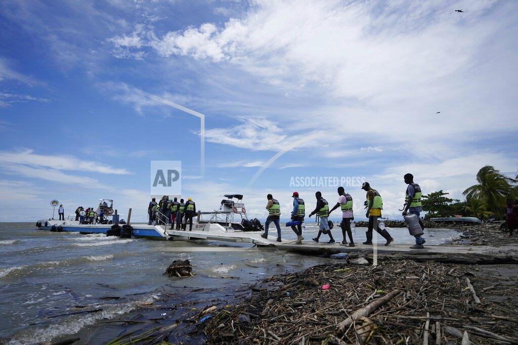 Fernando Vergara Haitian migrants walk toward boats that will take them from Necocli to Acandi, Colombia, near the border with Panama, Monday, Sept. 13, 2021. Migrants have been gathering in Necocli as they move north on their journey to the U.S. border. (AP Photo/Fernando Vergara)