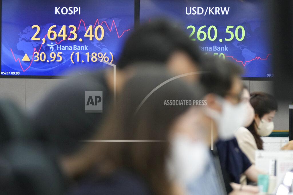 Lee Jin-Man Currency traders watch computer monitors near the screens showing the Korea Composite Stock Price Index (KOSPI), left, and the foreign exchange rate between U.S. dollar and South Korean won at a foreign exchange dealing room in Seoul, South Korea, Friday, May 27, 2022. Asian shares gained Friday as investors cheered a strong set of earnings from retailers that has sent U.S. shares higher. (AP Photo/Lee Jin-man)