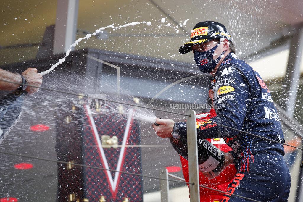 First place Red Bull driver Max Verstappen of the Netherlands, right, celebrates on the podium during the Monaco Grand Prix at the Monaco racetrack, in Monaco, Sunday, May 23, 2021. (Sebastien Nogier, Pool via AP)