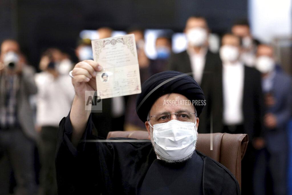 Ebrahim Noroozi Ebrahim Raisi, head of Iran's judiciary shows his identification document while registering his name as a candidate for the June 18 presidential elections at elections headquarters of the Interior Ministry in Tehran, Iran, Saturday, May 15, 2021. (AP Photo/Ebrahim Noroozi)