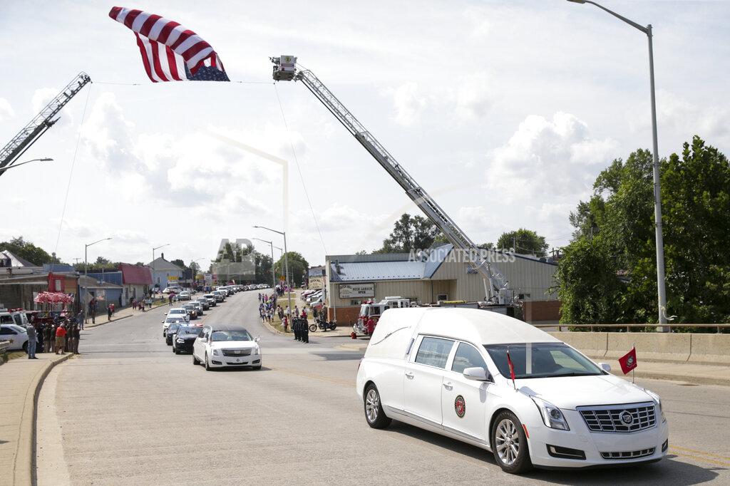 Nikos Frazier The funeral procession for Marine Cpl. Humberto Sanchez passes under an American flag, Tuesday, Sept. 14, 2021 in Logansport, Ind. Sanchez was one of 13 U.S. service members to die in an explosion during evacuation efforts in Afghanistan. (Nikos Frazier/Journal & Courier via AP)
