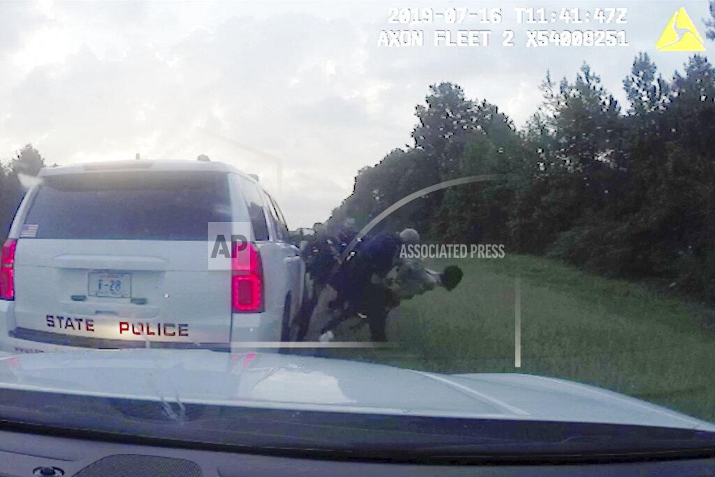 Uncredited In this July 16, 2019 image from police dashboard camera video obtained by The Associated Press, Louisiana State Trooper Jacob Brown throws motorist Morgan Blake to the ground following a traffic stop in Ouachita Parish, La., during which troopers found 13 pounds marijuana in the car Blake was driving. Brown threw Blake to the ground after he asked for his handcuffs to be adjusted. Trooper Randall "Colby" Dickerson then punched Blake five times and kneed him in the side, the footage shows. (Louisiana State Police via AP)