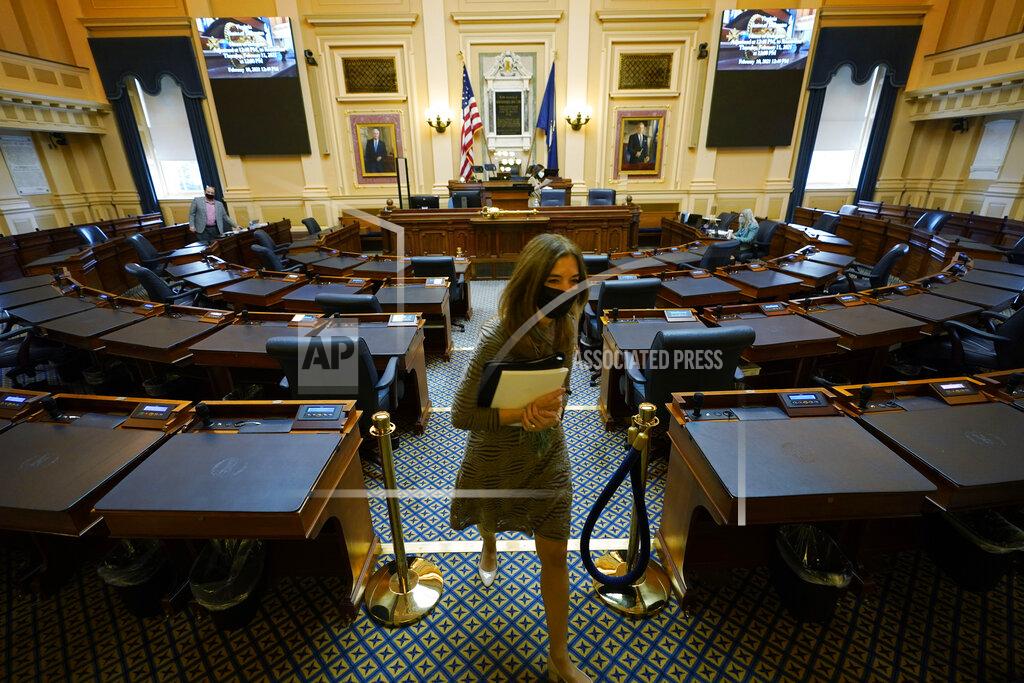 Steve Helber House speaker Del. Eileen Filler-Corn, D-Fairfax, exits the center isle of the empty VirginianHouse of Delegates chamber after a Zoom Legislative session at the Capitol in Richmond, Va., Wednesday, Feb. 10, 2021. (AP Photo/Steve Helber)