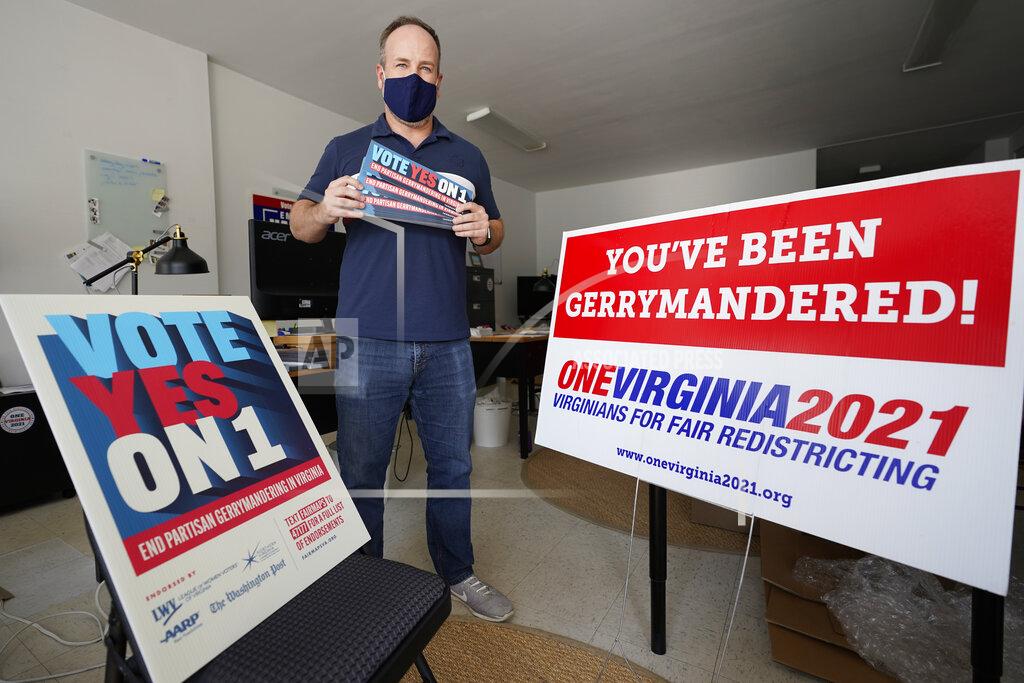 Steve Helber FILE - In this Oct. 6, 2020 file photo, redistricting reform advocate Brian Cannon poses with some of his yard signs and bumper stickers in his office in Richmond, Va. A new voter-approved commission in Ohio that was supposed to reduce partisanship in the once-a-decade process of political map-drawing has already become a flop. Similar commissions meeting for the first time in New York and Virginia have devolved into partisan finger-pointing, undermining their intent. (AP Photo/Steve Helber, File)