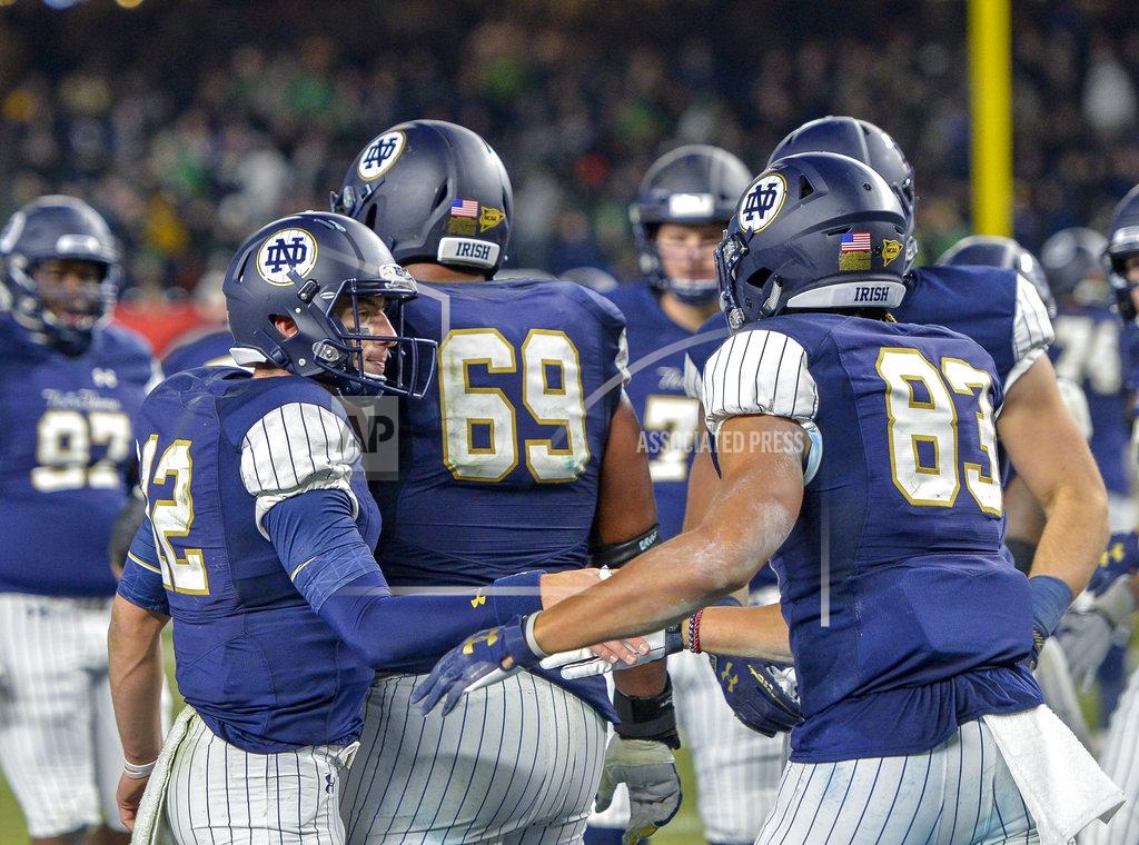 Howard Simmons Notre Dame quarterback Ian Book (12) congratulates wide receiver Chase Claypool (83) after a touchdown against Notre Dame during an NCAA college football game, Saturday, Nov. 17, 2018, at Yankee Stadium in New York. (AP Photo/Howard Simmons)