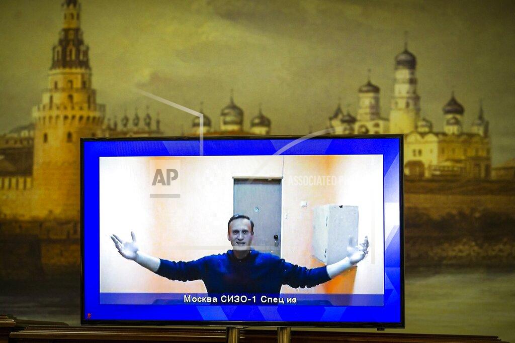 Alexander Zemlianichenko FILE - In this Jan. 28, 2021, file photo, Russian opposition leader Alexei Navalny appears on a TV screen during a court hearing appealing his jailing, with an image of the Kremlin in the background in Moscow, Russia. Navalny is serving a 2½-year prison sentence for violating parole for a conviction he says was politically motivated. In the months before the Sept. 19 parliamentary election, authorities unleashed an unprecedented crackdown on the opposition, making sure that the best-known and loudest Kremlin critics didn’t run. (AP Photo/Alexander Zemlianichenko, File)