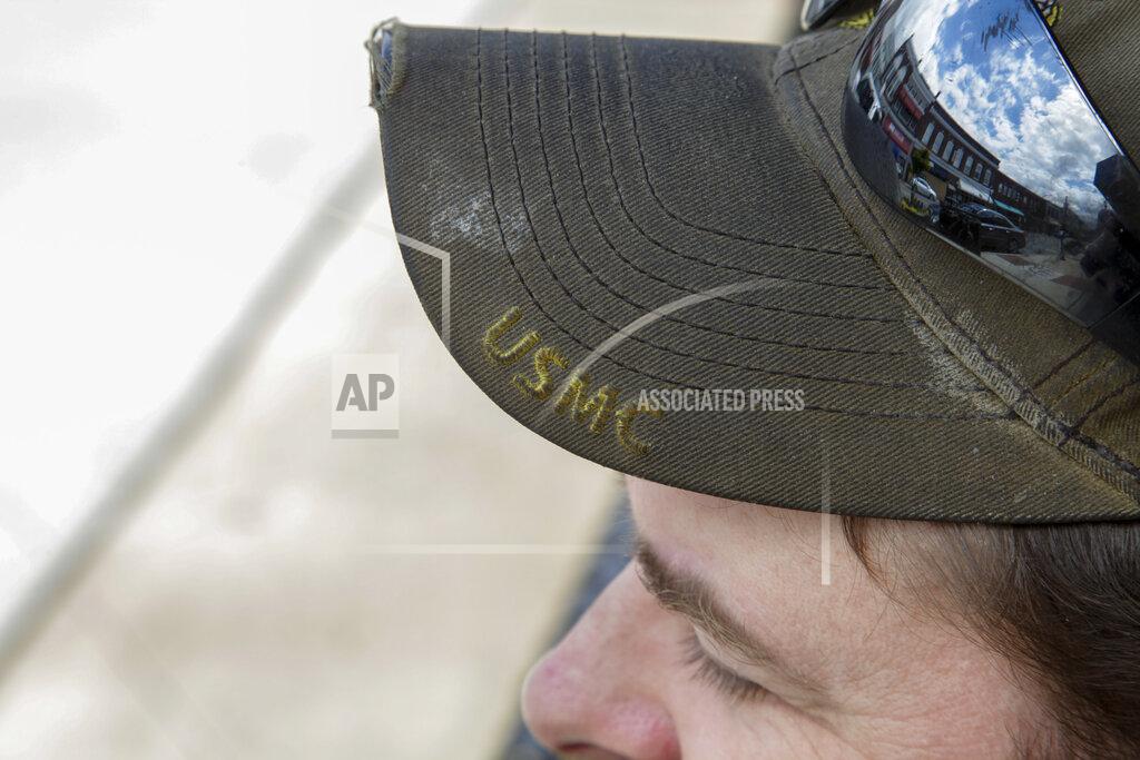 Sarah Blake Morgan This April 30, 2020, photo shows a hat of U.S. Marine Corps veteran Chad Sneary in Mooresville, N.C. Sneary was laid off from his manufacturing job in April. Sneary waits for unemployment to come through. "Financial skills is not something the military ever taught you," he said. (AP Photo/Sarah Blake Morgan)