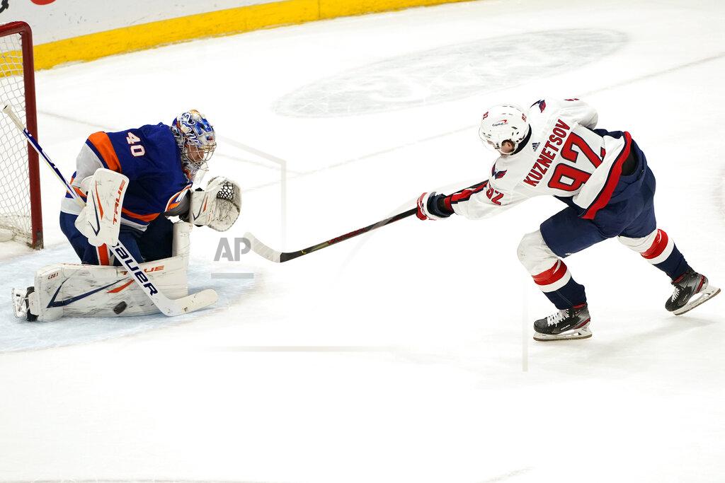 Kathy Willens Washington Capitals center Evgeny Kuznetsov (92) scores against New York Islanders goaltender Semyon Varlamov (40) during the shootout in an NHL hockey game, Thursday, April 22, 2021, in Uniondale, N.Y. (AP Photo/Kathy Willens)