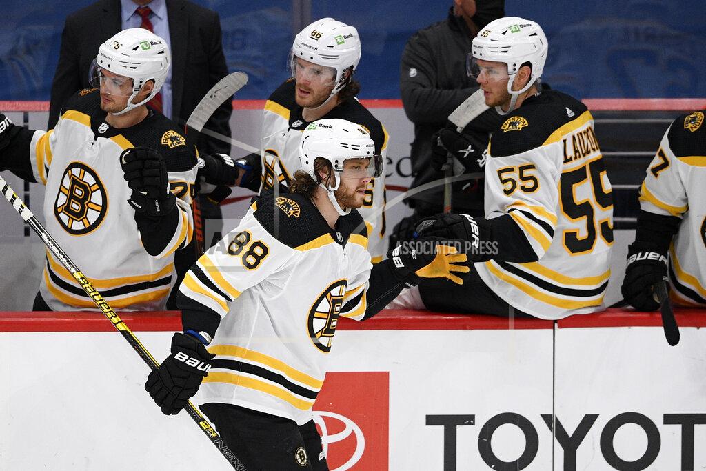 Nick Wass Boston Bruins right wing David Pastrnak (88) celebrates his goal with the bench during the second period of an NHL hockey game against the Washington Capitals, Monday, Feb. 1, 2021, in Washington. (AP Photo/Nick Wass)