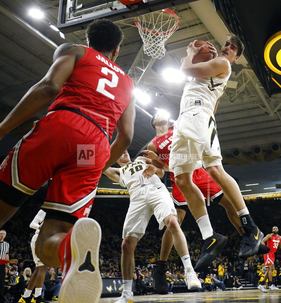 Matthew Putney Iowa forward Luka Garza, center, rips down a rebound during the first half against Ohio State in an NCAA college basketball game, Saturday, Jan. 12, 2019, in Iowa City Iowa. (AP Photo/Matthew Putney)