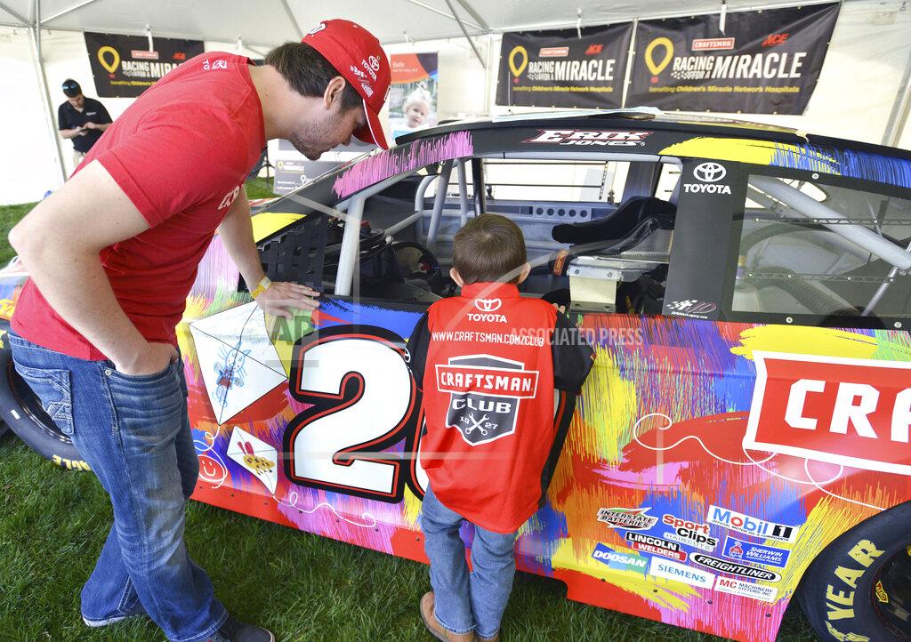 David Crigger Gavin Brewer, a 4-year old leukemia patient at Niswonger Children's Hospital in Johnson City, Tenn., talks with Nascar driver Erik Jones after the press conference in Johnson City, Tenn., compares her original drawing with the one on Erik Jones' Toyota, Thursday, April 4, 2019. Four patients from Niswonger helped design Jones' car for this weekend's race at Bristol Motor Speedway. Jones and the Ace Hardware Foundation as part of the Stanley Black & Decker "Racing for a Miracle" program presented a $100,000 check to hospital that could become a $1 million dollar check in Jones wins on Sunday. (David Crigger/Bristol Herald Courier via AP)