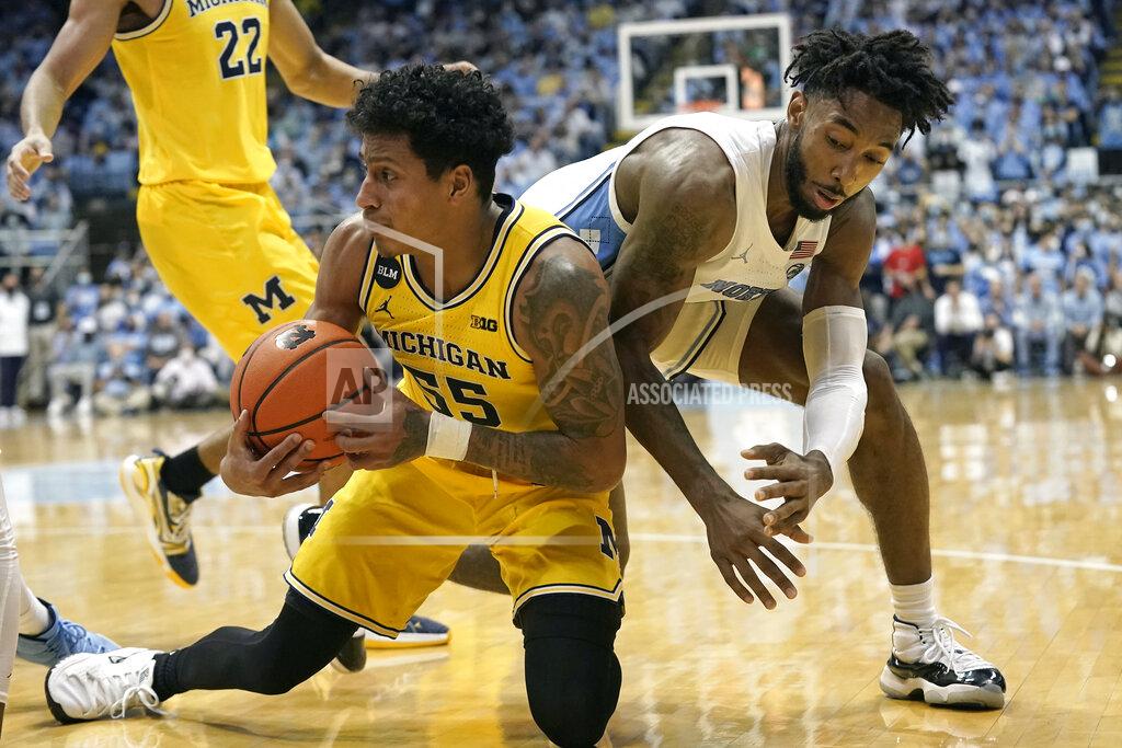 Gerry Broome North Carolina guard Leaky Black, right, tries to take the ball from Michigan guard Eli Brooks (55) during the second half of an NCAA college basketball game in Chapel Hill, N.C., Wednesday, Dec. 1, 2021. (AP Photo/Gerry Broome)
