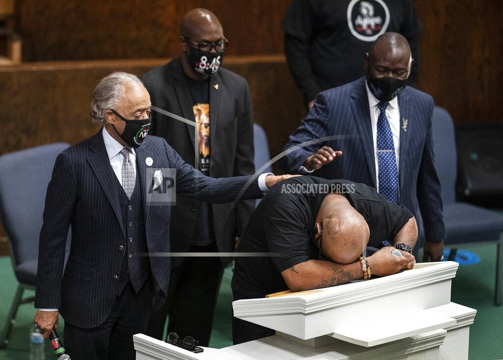 Jerry Holt Terrence Floyd, brother of George Floyd, speaks during a prayer service at Greater Friendship Missionary Church, as The Rev. Al Sharpton, left, his brother Philonise Floyd and attorney Ben Crump, right, place their hands on his back, Sunday, March 28, 2021, in Minneapolis. Opening statements are set for Monday in the trial of a former Minneapolis police officer charged with murder and manslaughter in George Floyd's death. (Jerry Holt/Star Tribune via AP)
