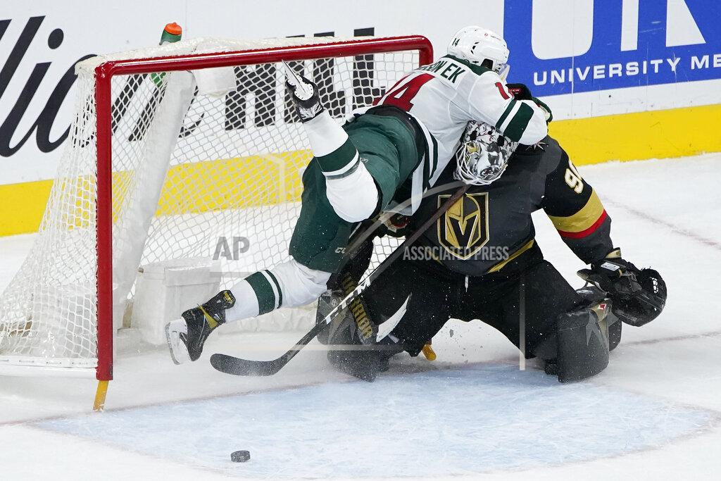 John Locher Minnesota Wild center Joel Eriksson Ek (14) falls into Vegas Golden Knights goaltender Robin Lehner (90) during overtime of an NHL hockey game Thursday, April 1, 2021, in Las Vegas. (AP Photo/John Locher)