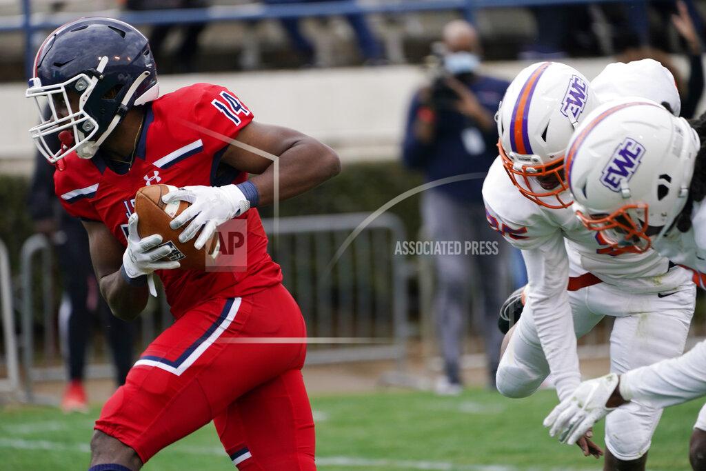 Rogelio V. Solis Jackson State wide receiver Christian Allen (14) sprints away from Edward Waters defenders during the second half of an NCAA college football game in Jackson, Miss., Sunday, Feb. 21, 2021. The game marked the coaching debut of Sanders. (AP Photo/Rogelio V. Solis)