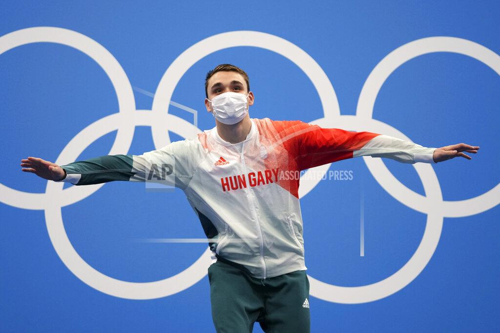 Matthias Schrader Kristof Milak of Hungary waves as he stands on the podium to receive his gold medal for the men's 200-meter butterfly final at the 2020 Summer Olympics, Wednesday, July 28, 2021, in Tokyo, Japan. (AP Photo/Matthias Schrader)