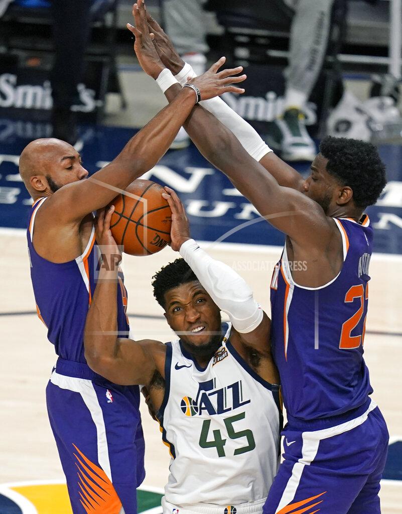 Rick Bowmer Phoenix Suns' Jevon Carter, left, and Deandre Ayton, right, defend against Utah Jazz guard Donovan Mitchell (45) during the first half of an NBA preseason basketball game Saturday, Dec. 12, 2020, in Salt Lake City. (AP Photo/Rick Bowmer)