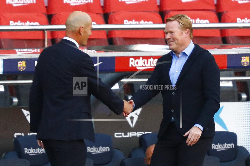 Joan Monfort Barcelona's head coach Ronald Koeman shakes hands with Real Madrid's head coach Zinedine Zidane during the Spanish La Liga soccer match between FC Barcelona and Real Madrid at the Camp Nou stadium in Barcelona, Spain, Saturday, Oct. 24, 2020. (AP Photo/Joan Monfort)