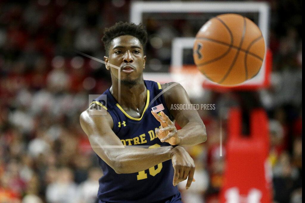 Julio Cortez Notre Dame guard TJ Gibbs passes to a teammate against Maryland during the first half of an NCAA college basketball game, Wednesday, Dec. 4, 2019, in College Park, Md. (AP Photo/Julio Cortez)