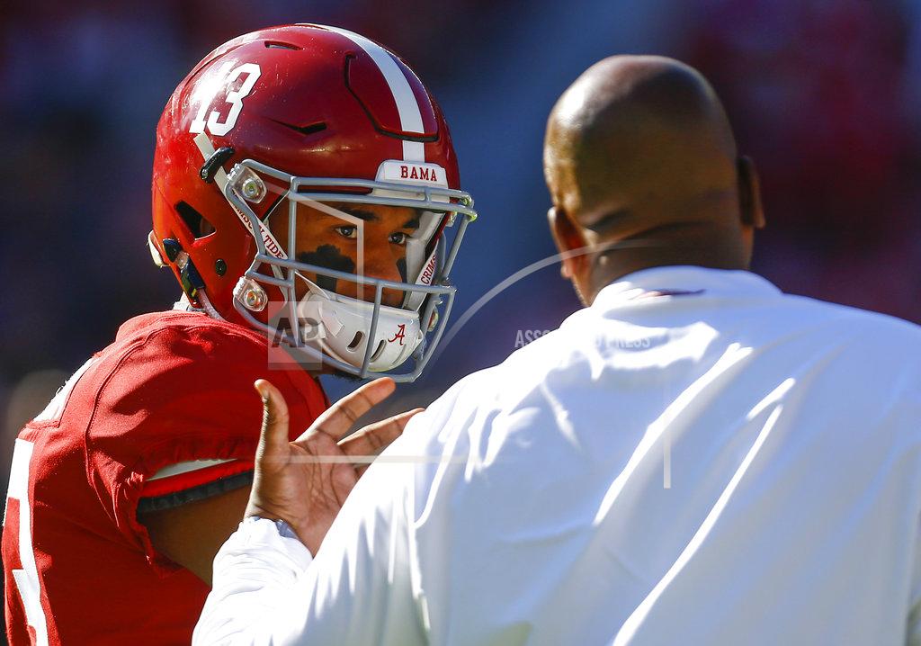 Butch Dill Alabama quarterback Tua Tagovailoa (13) talks with offensive coordinator Mike Locksley before an NCAA college football game against Mississippi State, Saturday, Nov. 10, 2018, in Tuscaloosa, Ala. (AP Photo/Butch Dill)