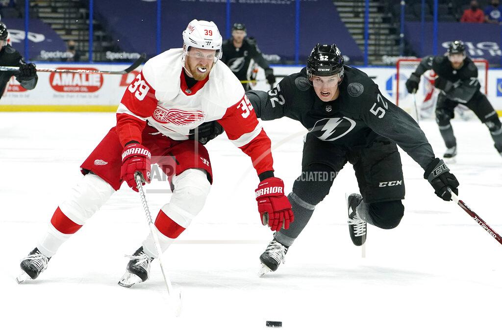 Chris O'MEara Detroit Red Wings right wing Anthony Mantha (39) gets around Tampa Bay Lightning defenseman Cal Foote (52) during the third period of an NHL hockey game Saturday, April 3, 2021, in Tampa, Fla. (AP Photo/Chris O'Meara)
