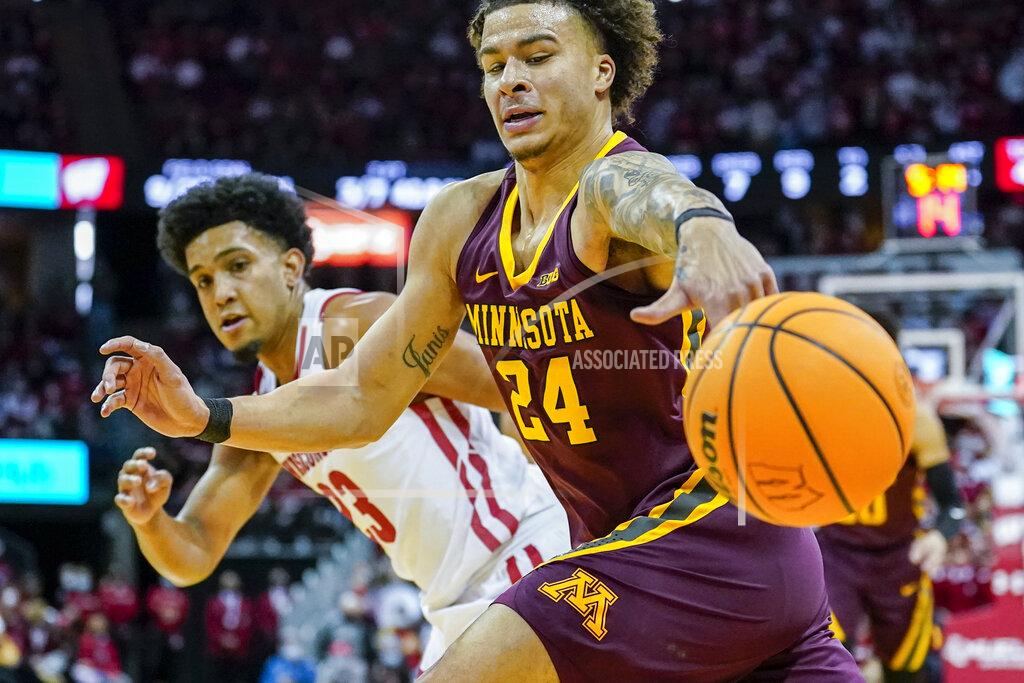 Andy Manis Minnesota's Sean Sutherlin (24) looses control of the ball against Chucky Hepburn during the first half of an NCAA college basketball game Sunday, Jan. 30, 2022, in Madison, Wis. (AP Photo/Andy Manis)