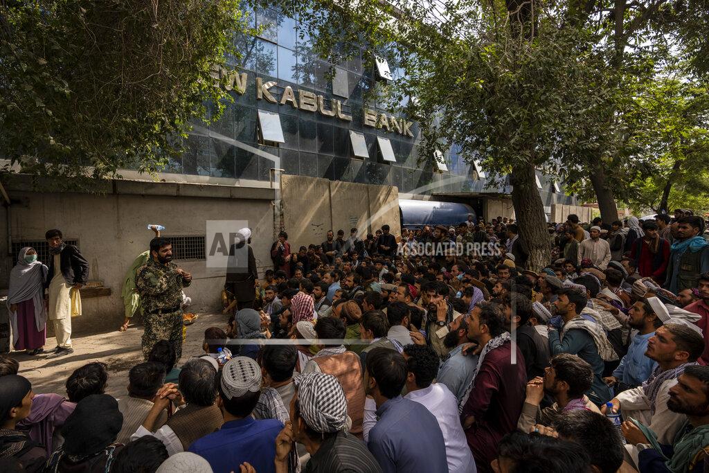 Bernat Armangue Afghans wait in front of a bank as they try to withdraw money in Kabul, Afghanistan, Sunday, Sept. 12, 2021. (AP Photo/Bernat Armangue)