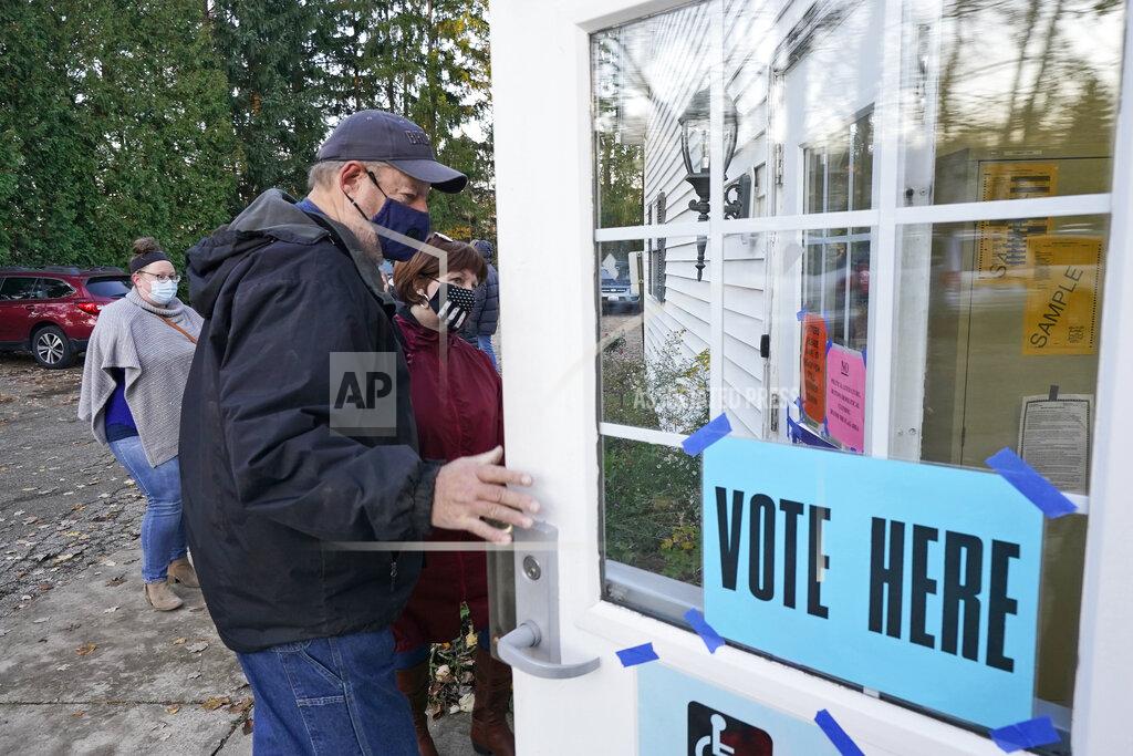 Tony Dejak A couple enter a polling station to vote on Election Day at the Middlefield Community Senior Center in Middlefield, Ohio, Tuesday, Nov. 3, 2020. (AP Photo/Tony Dejak)