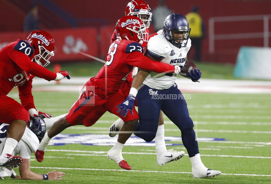 Gary Kazanjian Nevada running back Kelton Moore tries to shake loose from Fresno State defensive back Juju Hughes during the first half of an NCAA college football game in Fresno, Calif., Saturday, Nov. 23, 2019. (AP Photo/Gary Kazanjian)