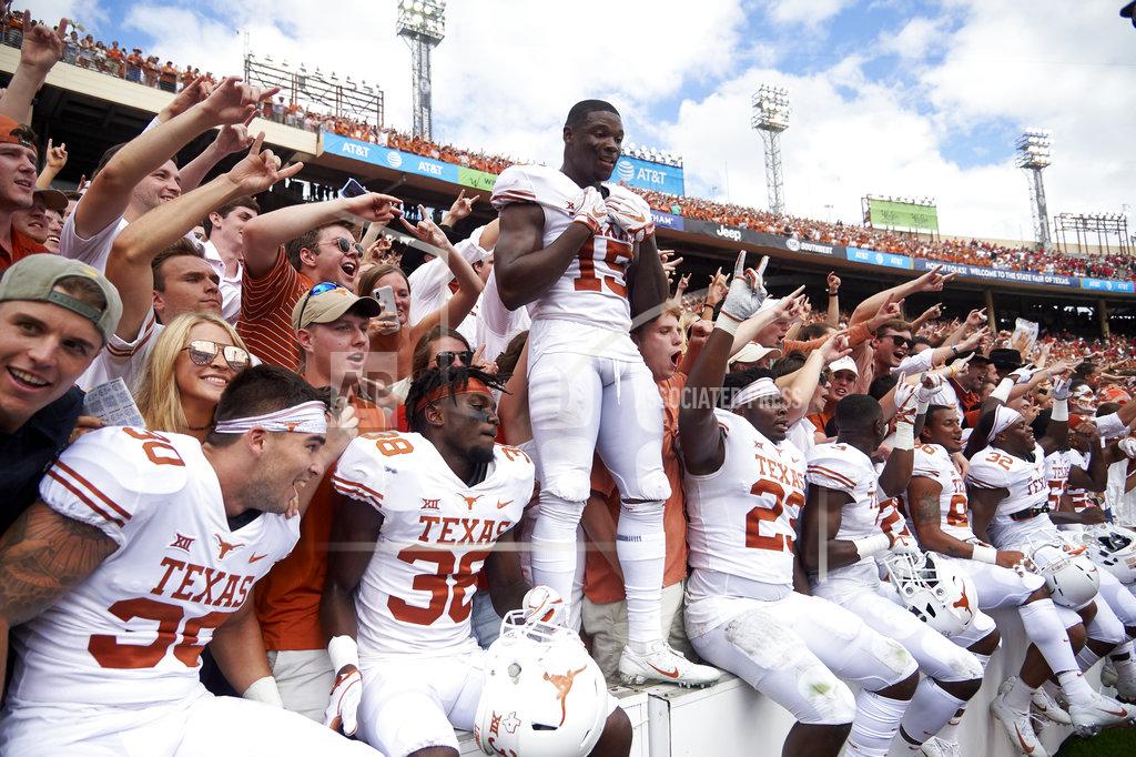 Cooper Neill Texas players celebrates after defeating Oklahoma 48-45 in an NCAA college football game at the Cotton Bowl, Saturday, Oct. 6, 2018, in Dallas. (AP Photo/Cooper Neill)