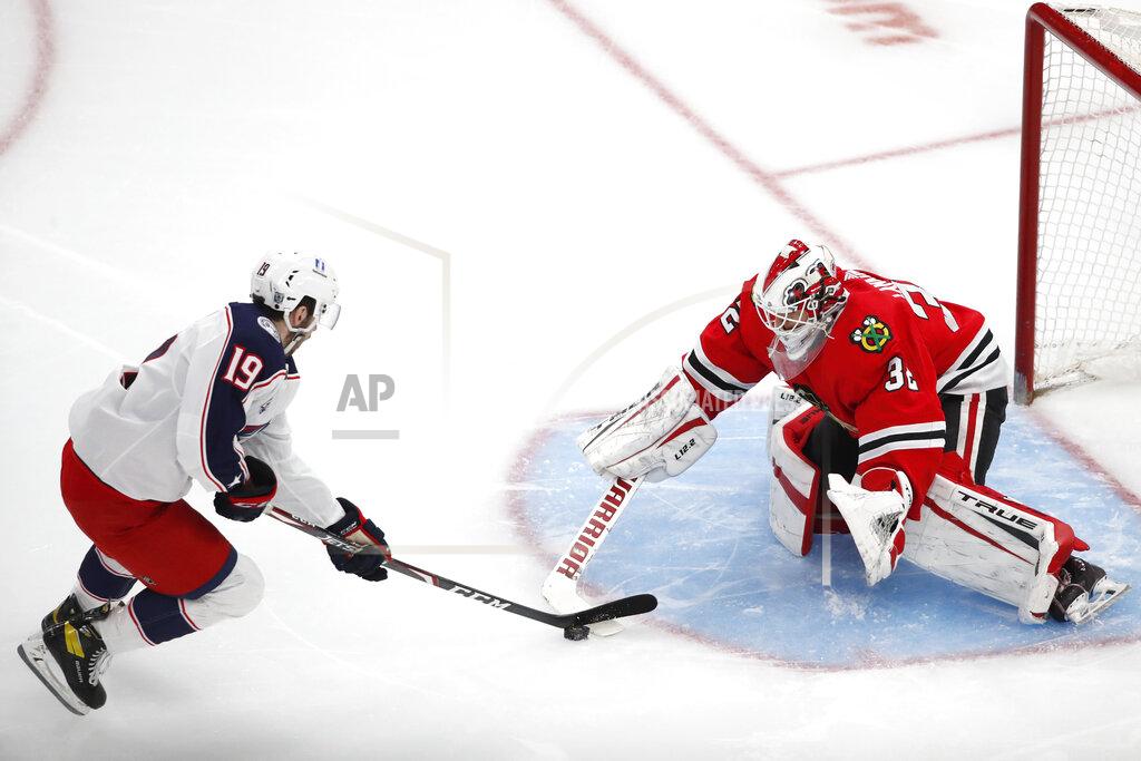 Jeff Haynes Chicago Blackhawks goaltender Kevin Lankinen (32) stops the shot of Columbus Blue Jackets center Liam Foudy (19) during the third period of an NHL hockey game Sunday, Jan. 31, 2021, in Chicago. (AP Photo/Jeff Haynes)