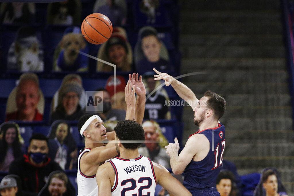 Young Kwak Saint Mary's guard Tommy Kuhse, right, passes the ball past Gonzaga guard Jalen Suggs, left, and forward Anton Watson during the first half of an NCAA college basketball game in Spokane, Wash., Thursday, Feb. 18, 2021. (AP Photo/Young Kwak)