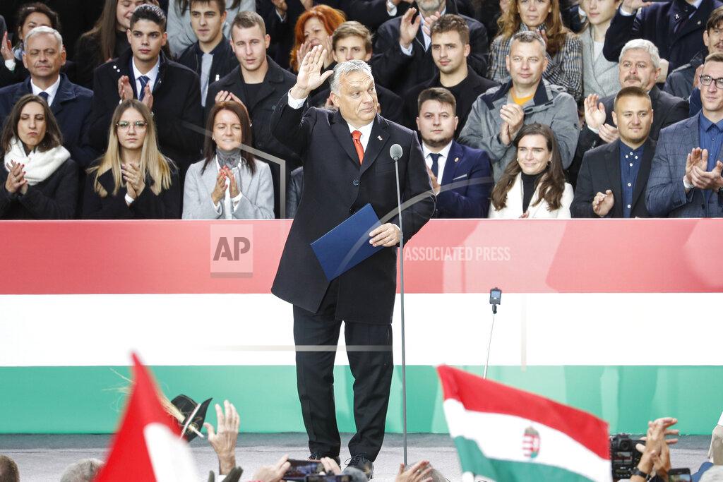 Laszlo Balogh Hungarian Prime Minister Viktor Orban waves to supporters during celebration the 65th anniversary of the 1956 Hungarian revolution, in Budapest, Hungary, Saturday, Oct. 23, 2021. Thousands of supporters of Prime Minister Viktor Orban, who is expected to deliver a speech marking the 65th anniversary of the 1956 Hungarian revolution, march in Budapest, Hungary to demonstrate loyalty to his right-wing government. (AP Photo/Laszlo Balogh)