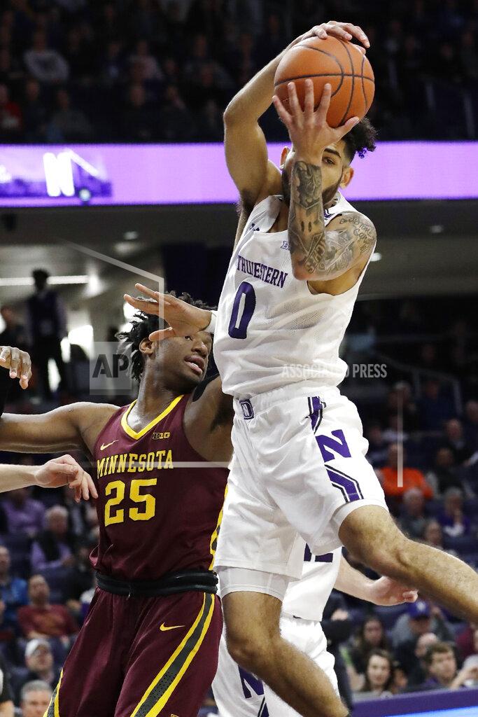 Nam Y. Huh Northwestern guard Boo Buie, right, rebounds a ball against Minnesota center Daniel Oturu during the first half of an NCAA college basketball game in Evanston, Ill., Sunday, Feb. 23, 2020. (AP Photo/Nam Y. Huh)