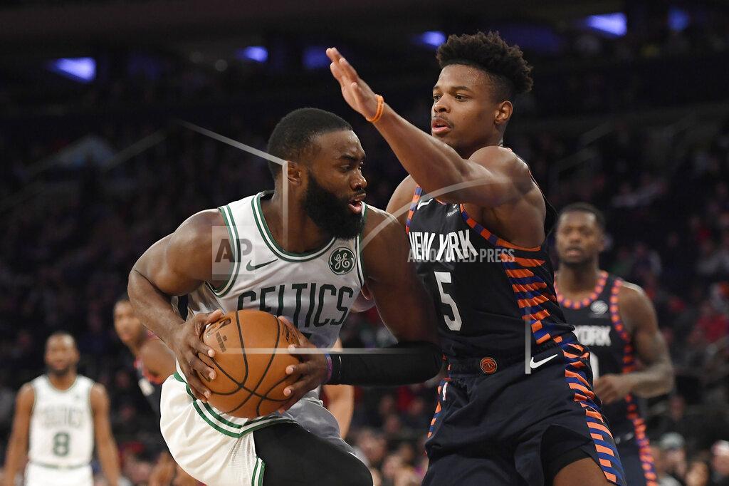Sarah Stier New York Knicks guard Dennis Smith Jr. (5) defends against Boston Celtics guard Jaylen Brown during the second half of an NBA basketball game, Sunday, Dec. 1, 2019, in New York. (AP Photo/Sarah Stier)