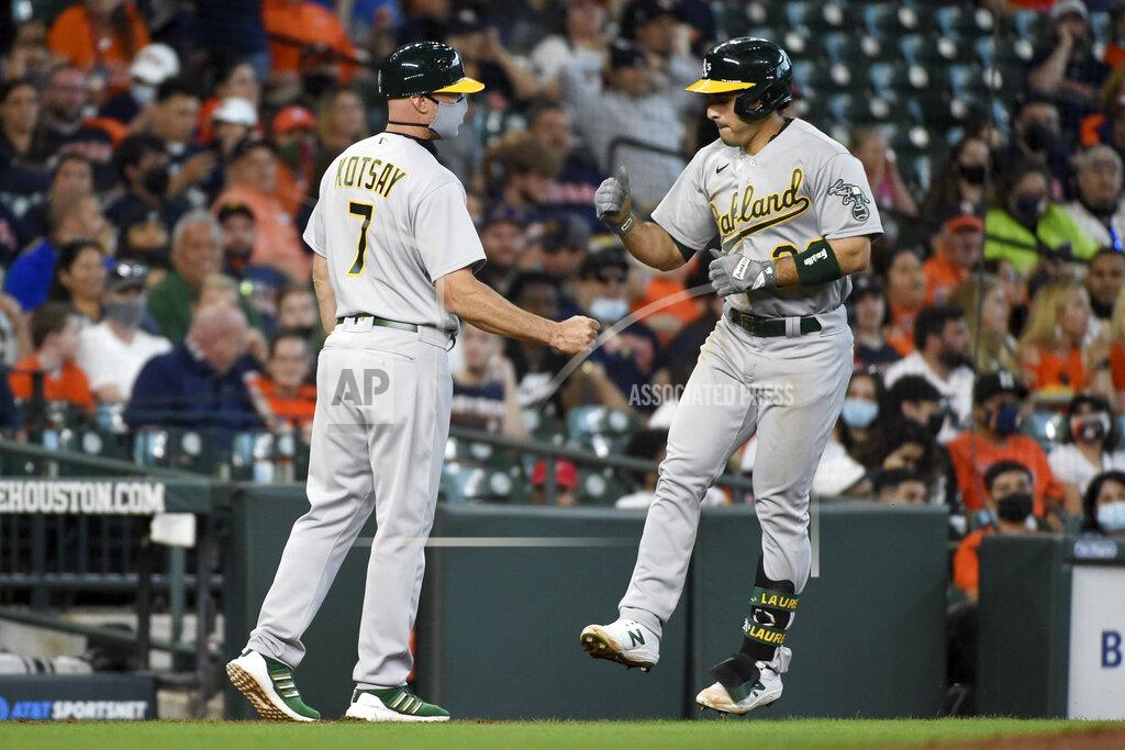 Eric Christian Smith Oakland Athletics' Ramon Laureano, right, celebrates his two-run home run with third base coach Mark Kotsay during the fifth inning of a baseball game against the Houston Astros, Saturday, April 10, 2021, in Houston. (AP Photo/Eric Christian Smith)