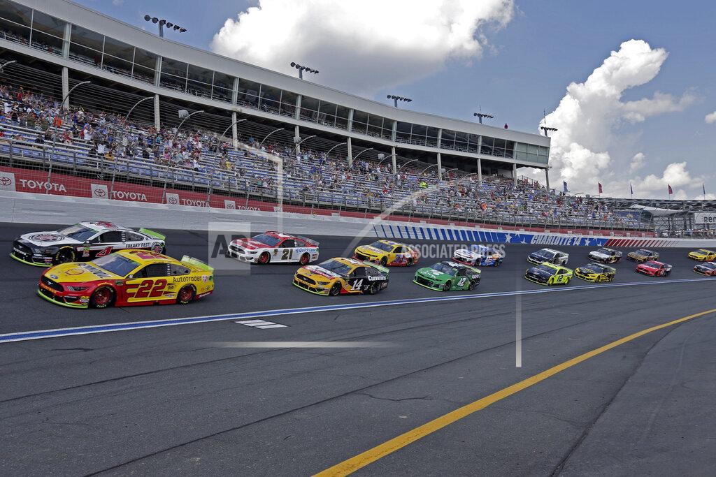 Gerry Broome Cars drive through Turn 4 to start the NASCAR Cup Series auto race at Charlotte Motor Speedway in Concord, N.C., Sunday, Sept. 29, 2019. (AP Photo/Gerry Broome)