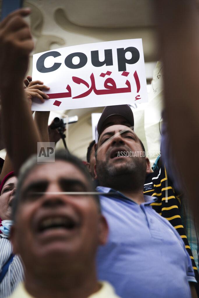 Riadh Dridi Tunisian demonstrators gather outside the Municipal Theatre of Tunis during a protest against Tunisian President Kais Saied, Saturday, Sept. 18, 2021. In July Tunisian President Kais Saied fired the country's prime minister and froze parliament's activities after violent demonstrations over the country's pandemic and economic situation. The movement made by Saied was considered by his opponents as a coup. (AP Photo/Riadh Dridi)
