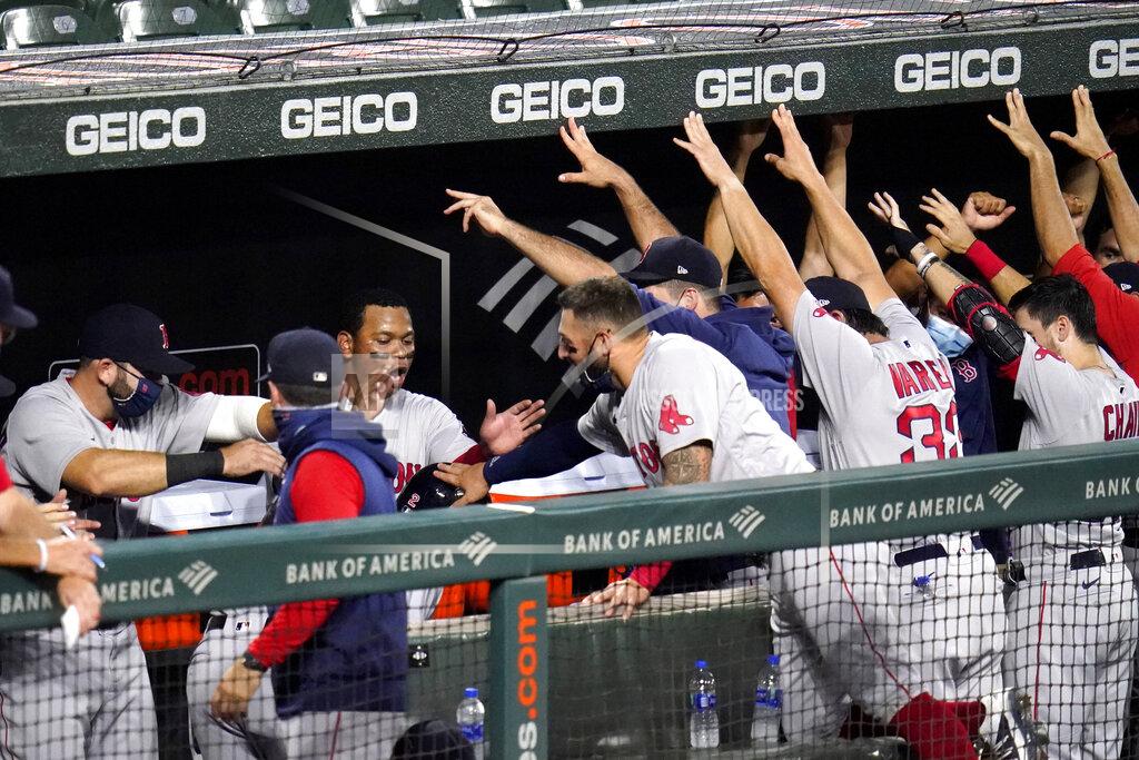 Julio Cortez Boston Red Sox players great Xander Bogaerts (2) in the dugout after he hit a solo home run off Baltimore Orioles starting pitcher John Means during the second inning of a baseball game, Friday, Aug. 21, 2020, in Baltimore. (AP Photo/Julio Cortez)